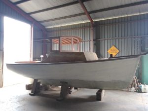 Image of a timber boat in workshop