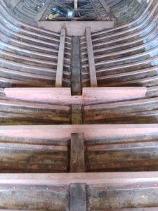 Image of a wooden boat being restored