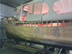 Image of a wooden boat being restored