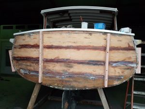 Image of a wooden boat being restored